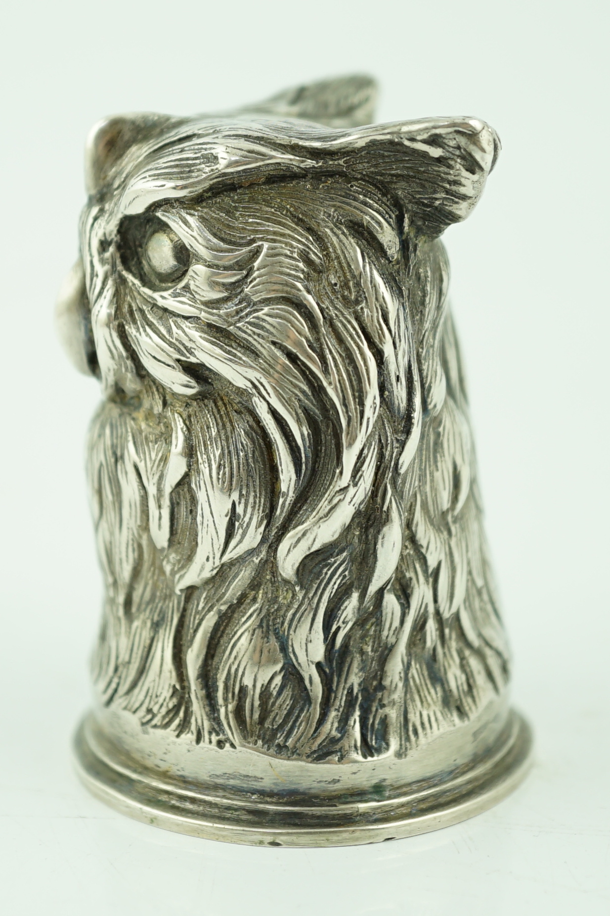 An early 20th century Russian 84 zolotnik 'stirrup' cup, modelled as the head of an owl, maker H.W.